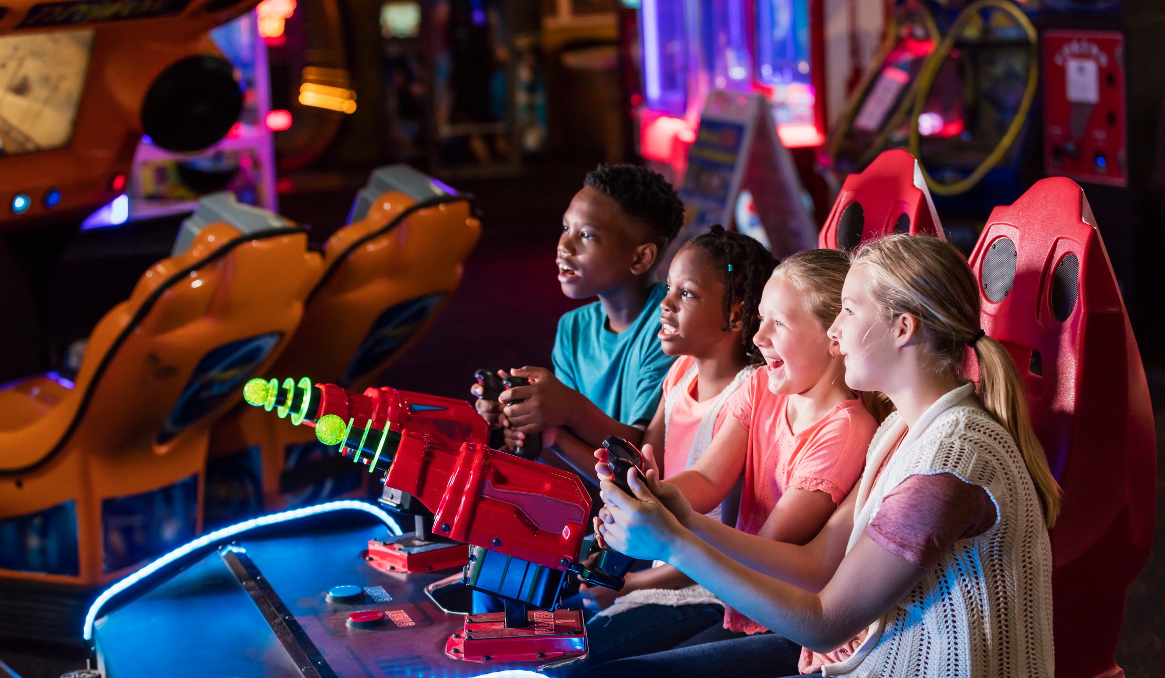 Group of kids playing arcade games