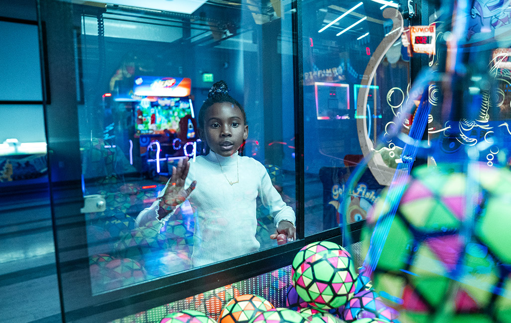 child playing claw machine game