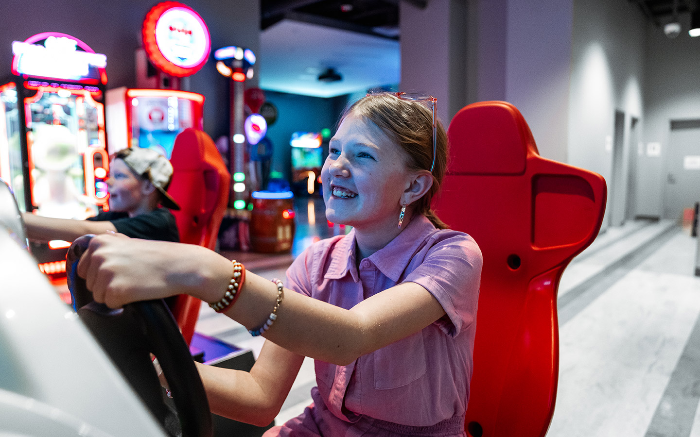 girl and boy playing against each other in racing game